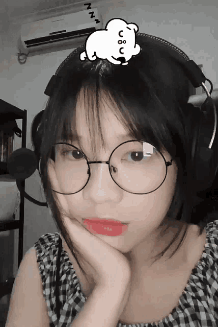 a girl wearing glasses and headphones has a sticker on her head that says zzz