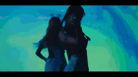 a man and woman are dancing in a dark room
