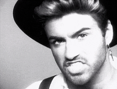 a black and white photo of a man wearing a hat and suspenders .