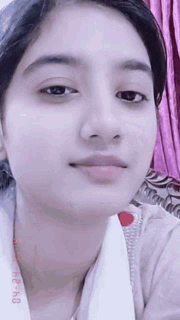 a close up of a woman 's face with a pink curtain behind her and a date stamp of 04.12.2020