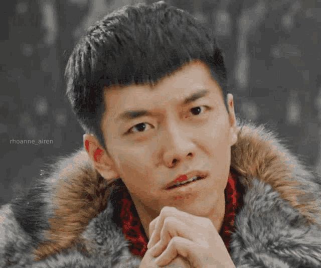 a close up of a man wearing a fur jacket