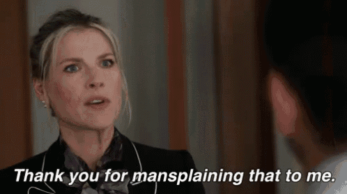 a woman is talking to a man in a suit and says `` thank you for mansplaining that to me . ''