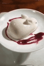 a white dessert in the shape of a rabbit on a plate