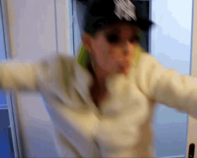 a blurry picture of a woman wearing a white jacket