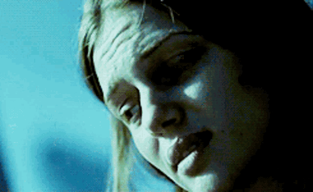 a close up of a woman 's face in the dark