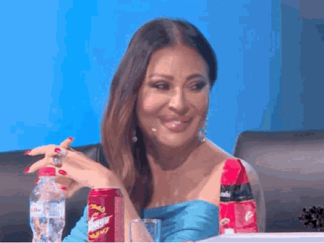 a woman sits in front of a can of pringles chips