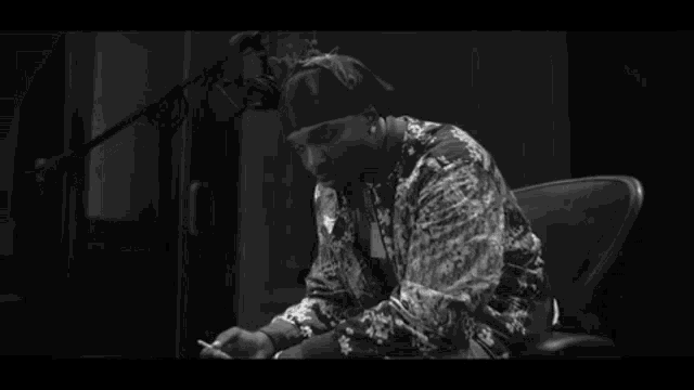 a black and white photo of a man wearing a bandana