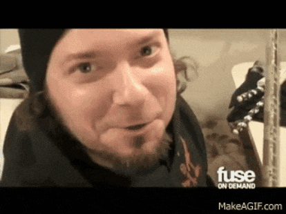 a man with a beard is making a funny face in front of a sign that says fuse