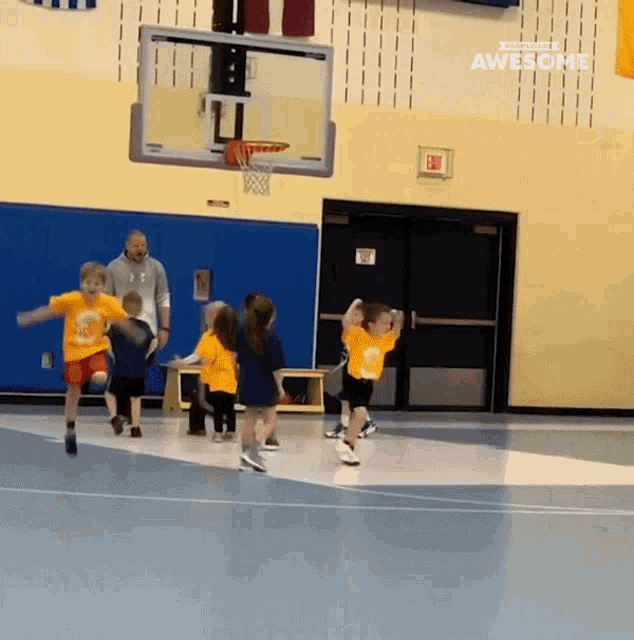 a group of kids are playing basketball in a gym and the words awesome are on the bottom right