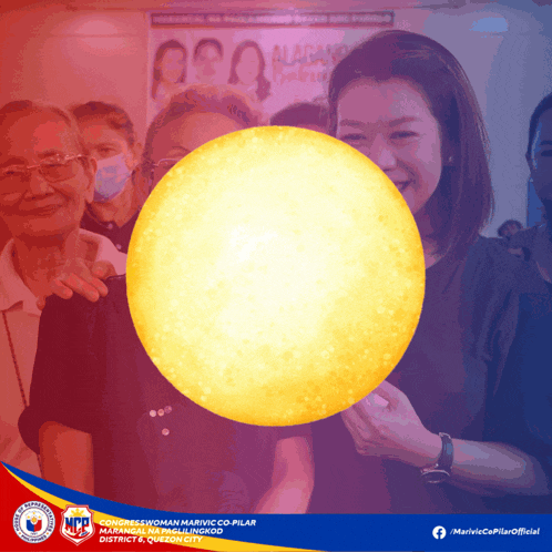 a woman is holding a large yellow ball in front of a group