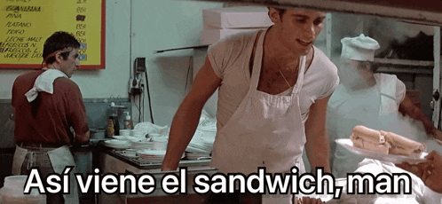 a man in an apron is holding a sandwich in front of a sign that says " así viene el sandwich man "