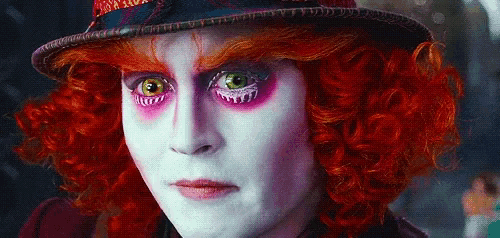 a close up of a person 's face with red hair and a hat on