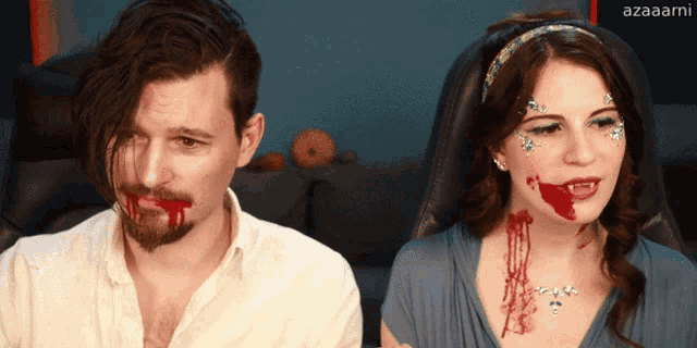 a man and a woman with blood on their faces are sitting next to each other with azaaami written in the corner