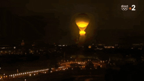 a hot air balloon is lit up at night with the number 2 visible