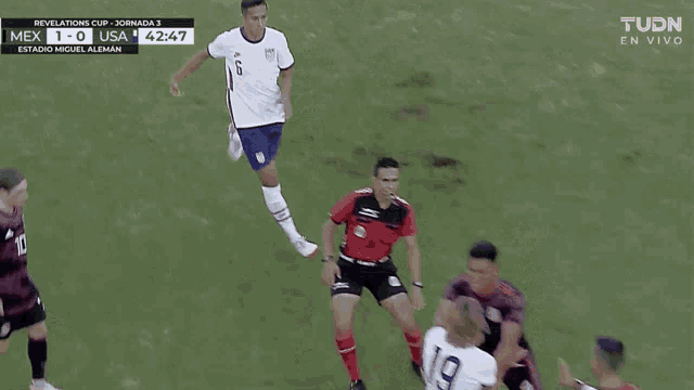a soccer game is being played between mexico and usa and the score is 1-0