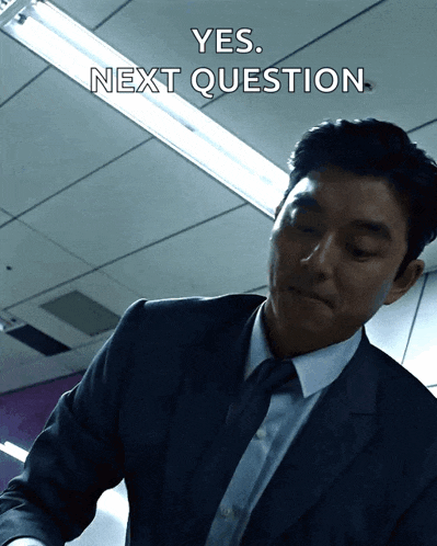a man in a suit and tie is asking the next question