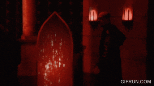 a gif from gifrun.com shows a man in a dark room with red lights