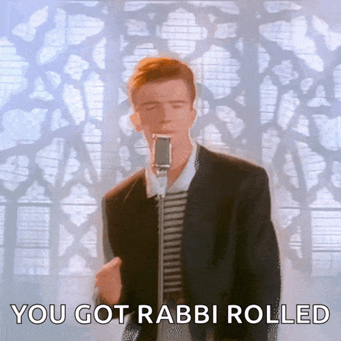 a man in a suit singing into a microphone with the words you got rabbi rolled below him