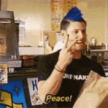 a man in a black shirt that says peace