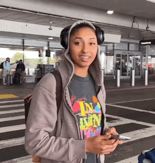 a woman wearing headphones and a t-shirt that says i 'm in love