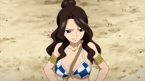 a woman in a blue and white checkered bikini is standing in the dirt