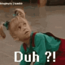 a little girl is laying on the floor and making a funny face with the words duh ?