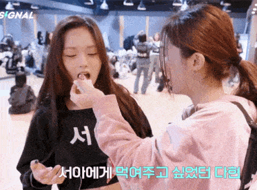 a girl wearing a black shirt with korean writing on it