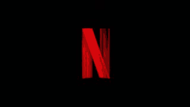 the netflix logo is red and glowing in the dark .