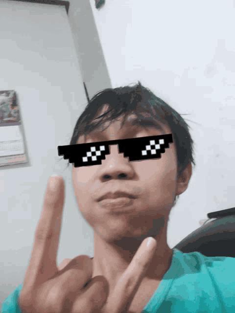 a man wearing a pair of pixelated glasses giving the middle finger