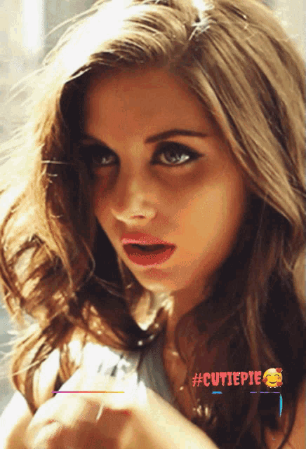 a close up of a woman 's face with #cutiepie written on the bottom right