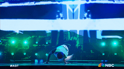a man is doing a handstand in front of a screen that says nbc