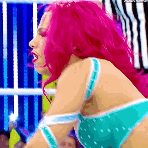 a woman with pink hair is wearing a blue and white bra