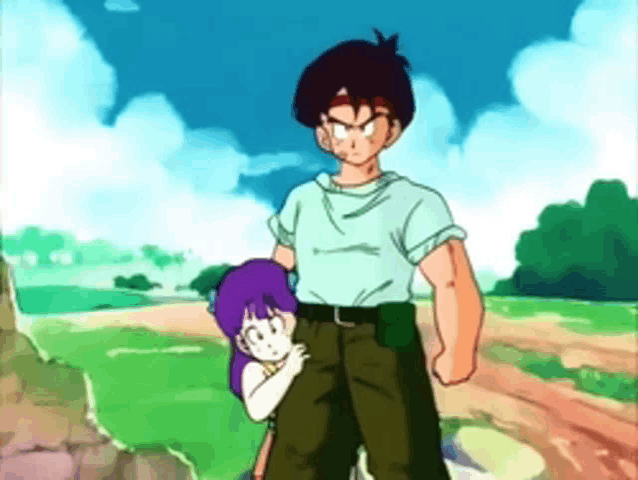 a boy and a girl are standing in a field