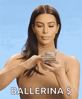 a woman is holding a stack of money in her hands and says ballerina $ .