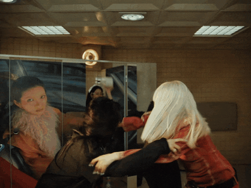 a woman with white hair is standing in front of a mirror with a picture of a woman on it