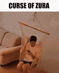 a man is sitting in a hammock looking at his phone and the caption curse of zura
