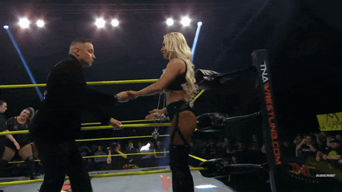 a man and a woman in a wrestling ring with the word benchmark on the bottom right