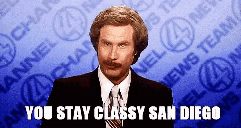 a man in a suit and tie is standing in front of a blue background with the words `` you stay classy san diego '' .