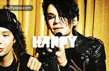 a man in a leather jacket is holding a microphone with the word happy on it