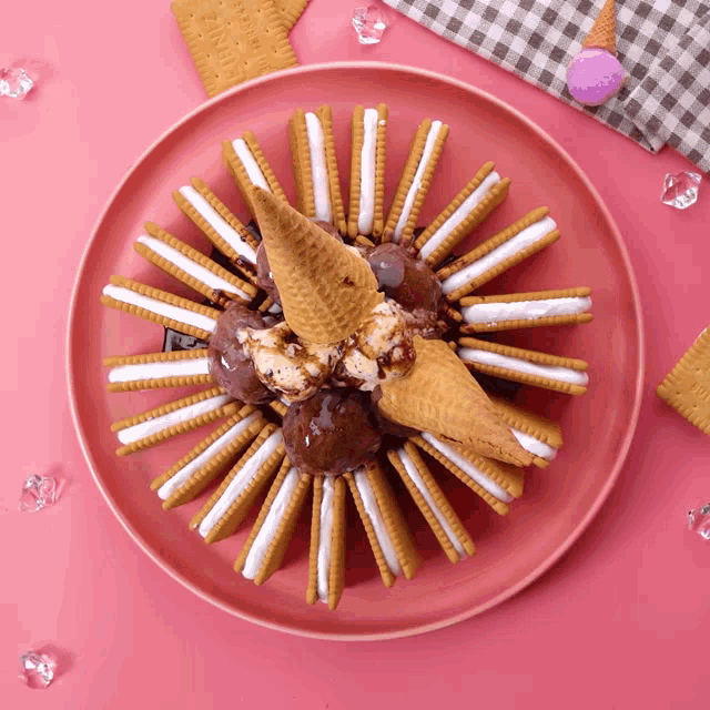 a plate of cookies and ice cream with a cone on top