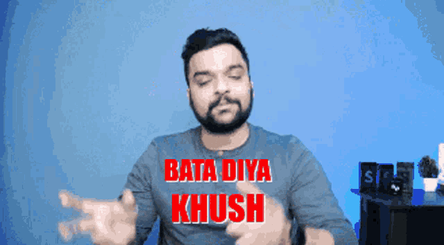 a man with a beard wears a blue shirt that says bata diya khush