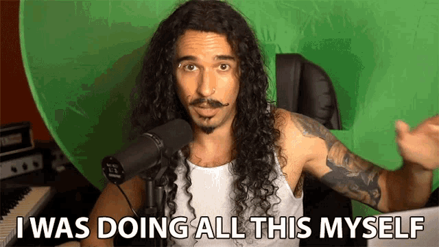a man with long curly hair and a mustache says " i was doing all this myself "