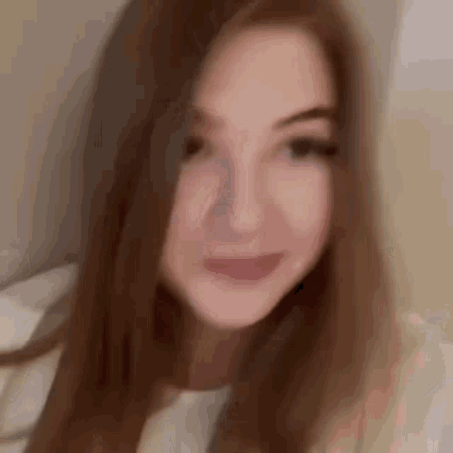 a close up of a woman 's face with a blurry background .