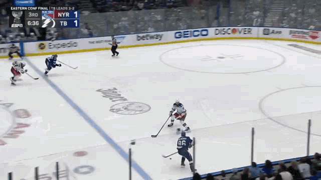 a hockey game is being played with advertisements for geico and honda on the ice