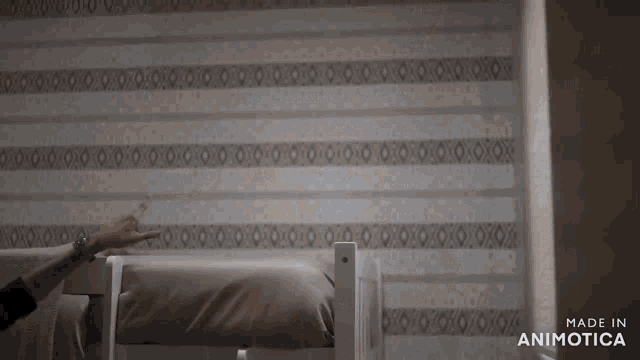 a woman is standing in a room with bunk beds and a ladder .