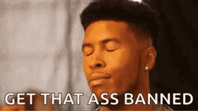 a man with his eyes closed and the words `` get that ass banned '' on his face .