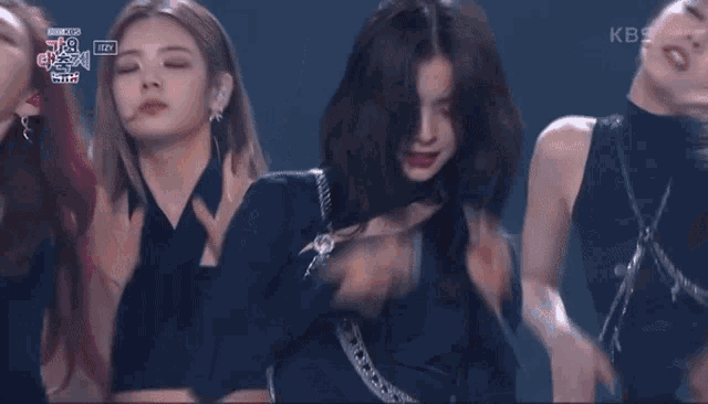 a group of girls are on a stage with kbs written on the bottom right