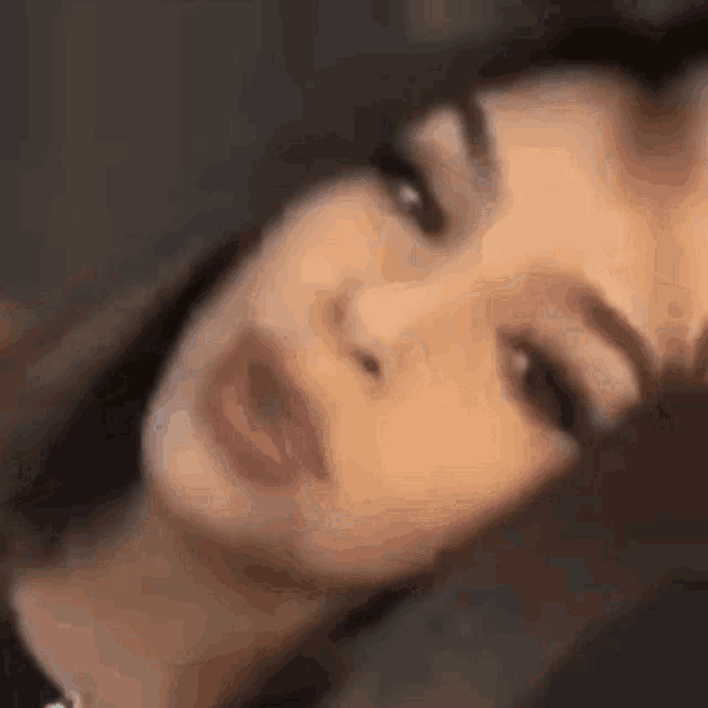 a close up of a woman 's face with her eyes closed and her mouth open .