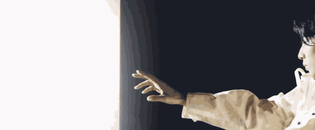 a person is reaching out towards a white light
