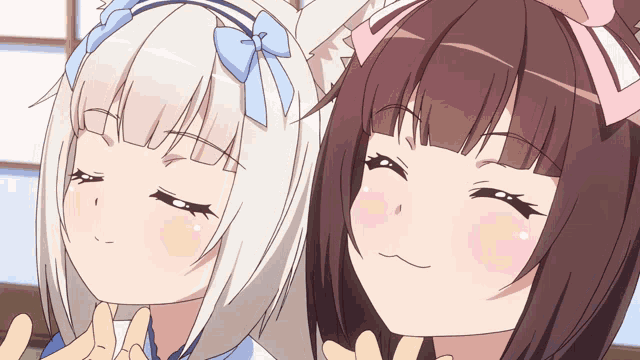 two anime girls with bows on their ears are looking at the camera